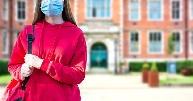 Student with a face mask outside the Students' Union 